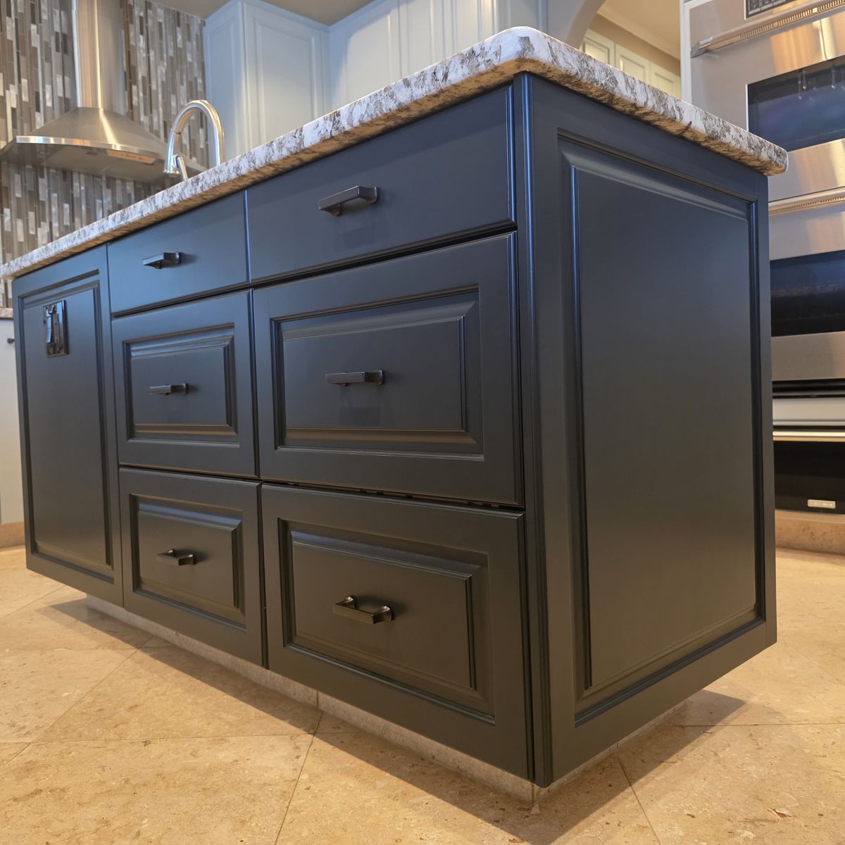 Kitchen island cabinets painted navy blue by Renovari