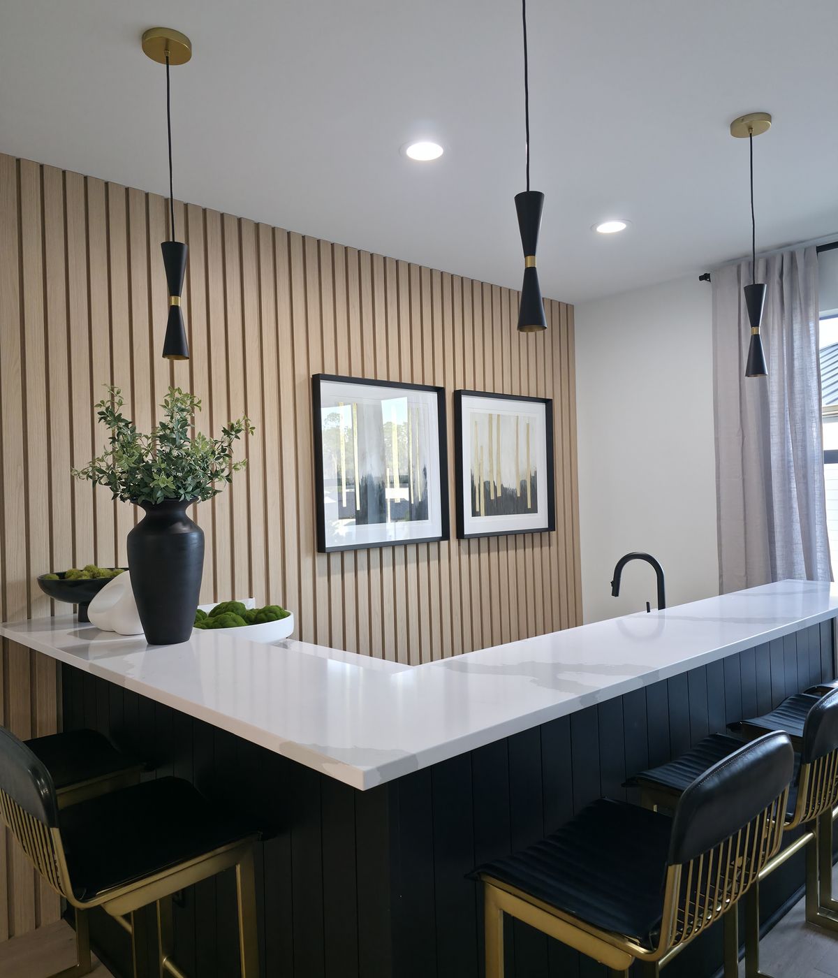 Custom wood slat accent wall and bar finished by Renovari