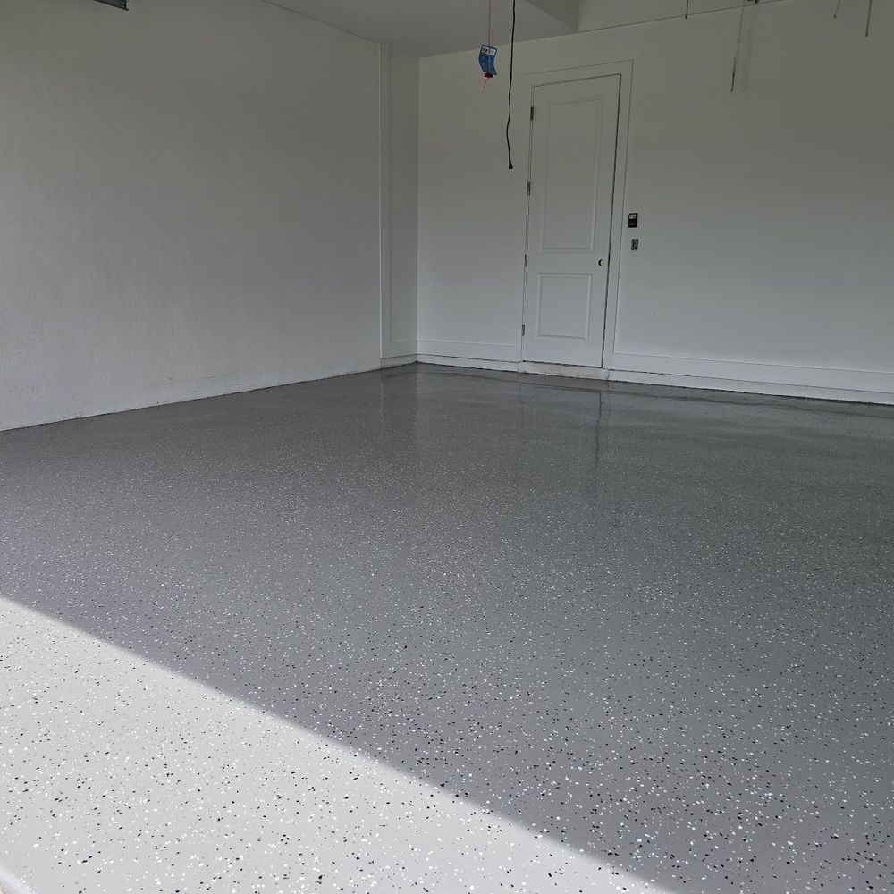 Gray flake epoxy garage floor installed by Renovari