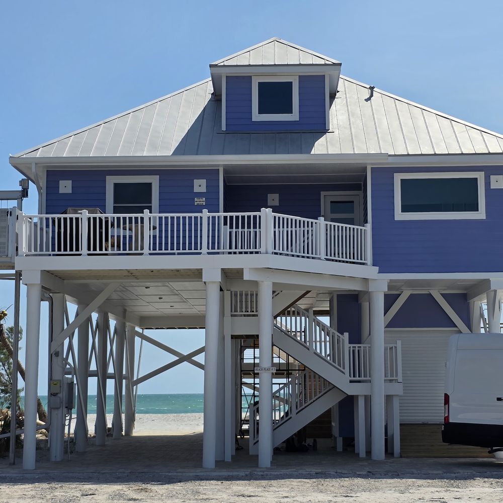 Coastal home exterior repainted in blue by Renovari, painters serving Punta Gorda FL