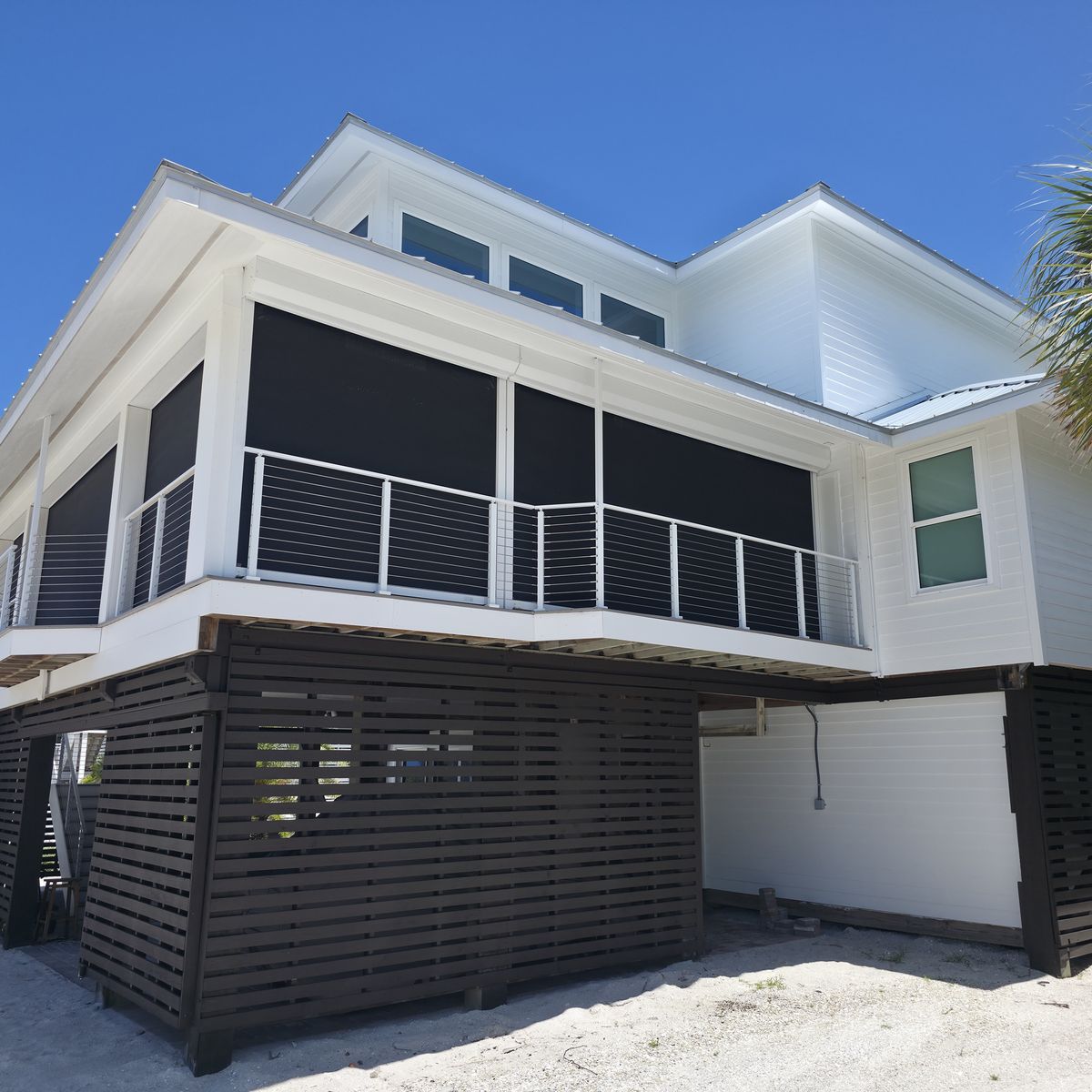 Coastal home exterior repainted in white by Renovari