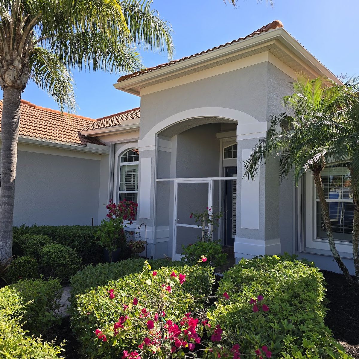 Stucco home exterior repainted in gray by Renovari
