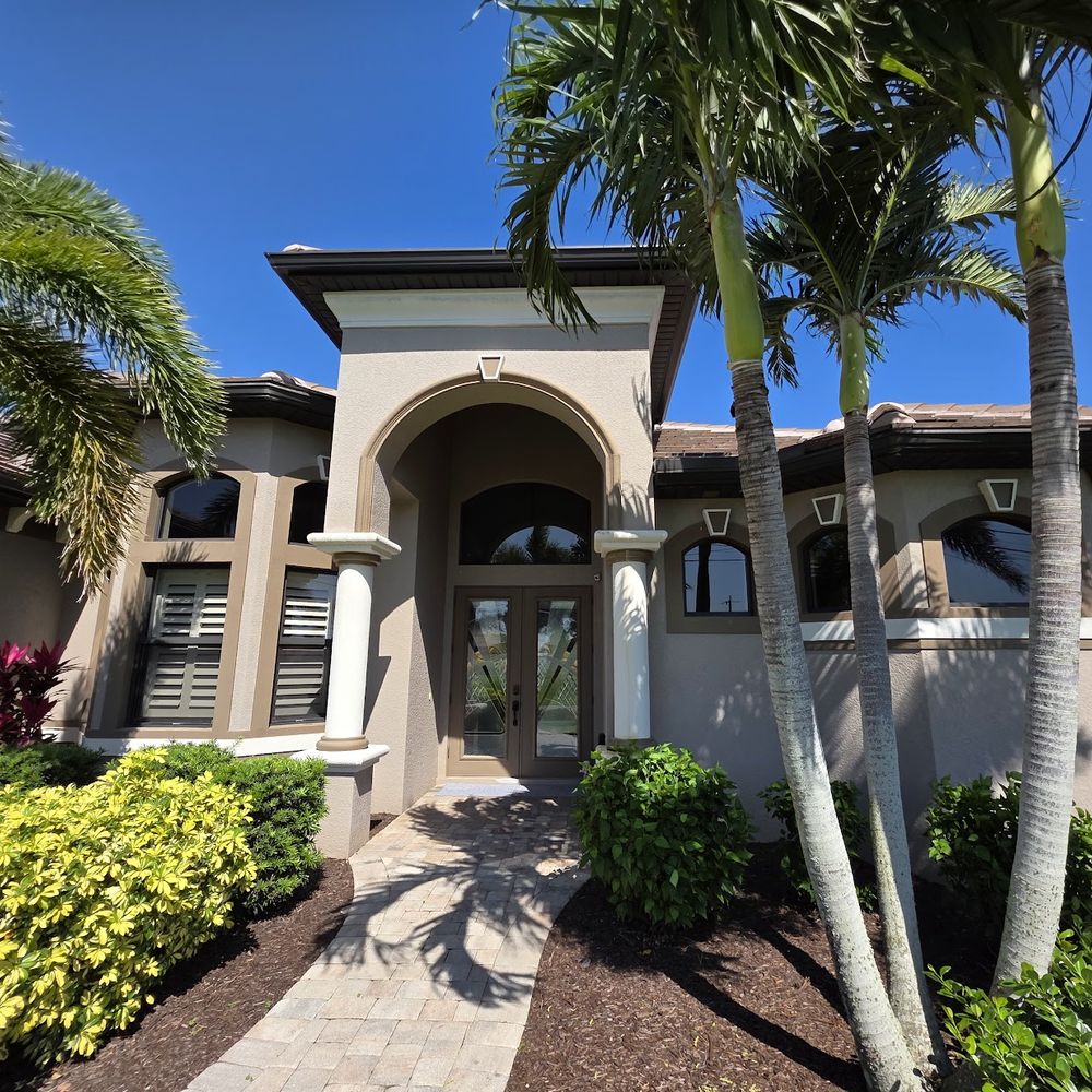 Stucco home exterior repainted by Renovari, painters serving Cape Coral FL