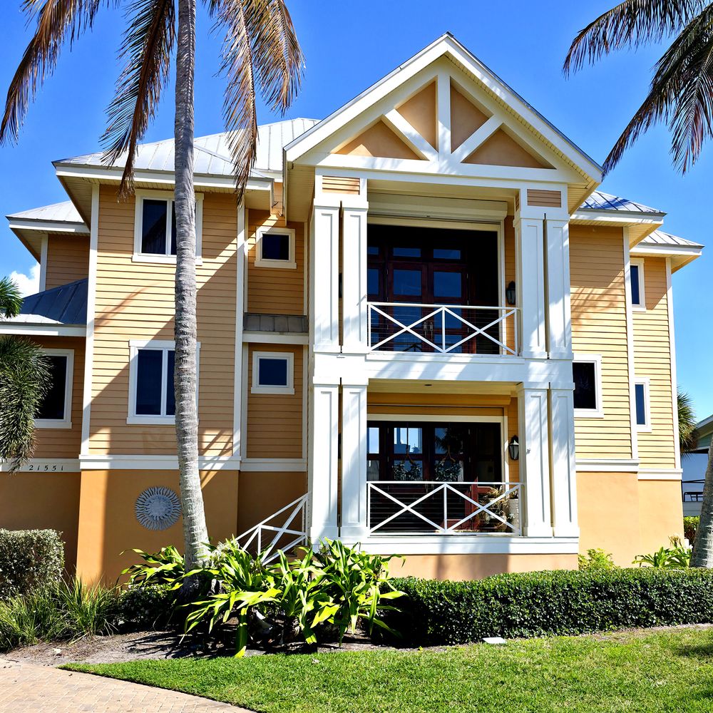 Two-story home exterior repainted by Renovari, painters serving Bonita Springs FL