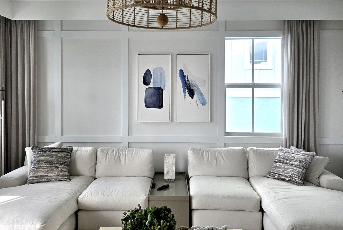 Living room with white board and batten paneled wall painted by Renovari