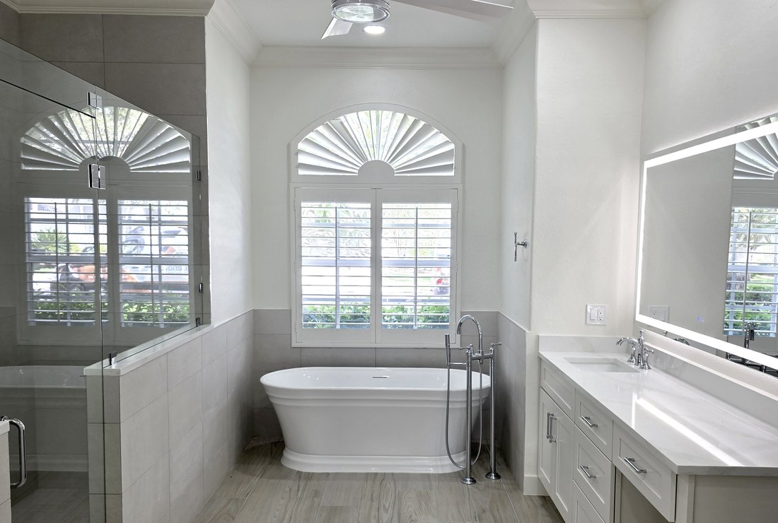 Primary bathroom with walls, ceiling and trim painted white by Renovari