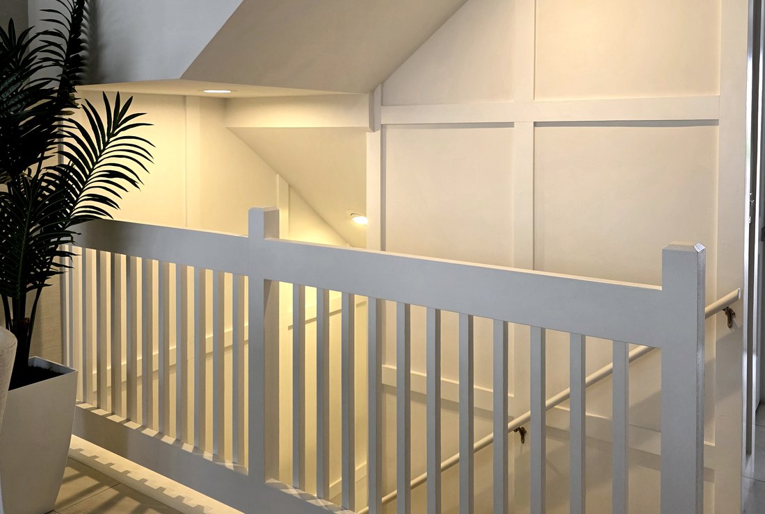 Stairwell with white board and batten walls painted by Renovari