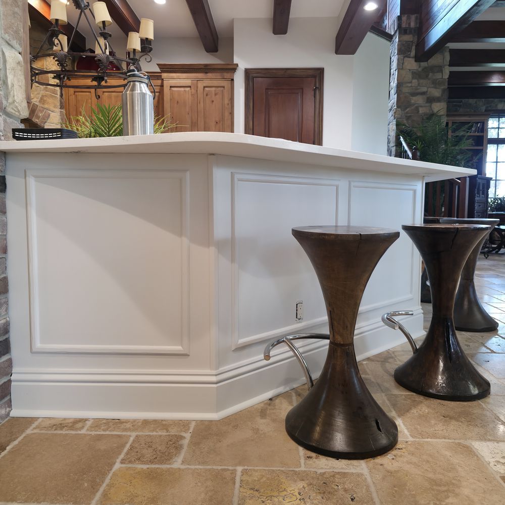 Kitchen island repainted from wood stain to white by Renovari