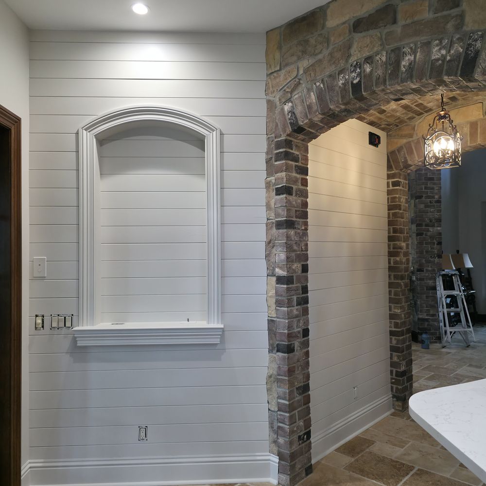 Shiplap wall and niche painted white by Renovari
